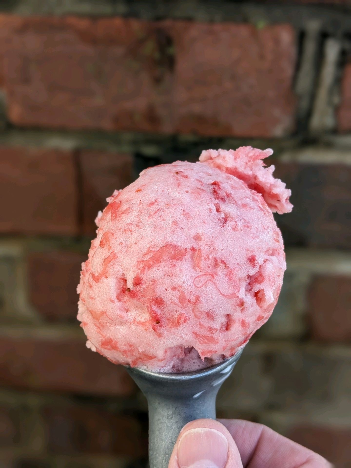 Strawberry pineapple sorbet. Crushed strawberry and pineapple mixed together to make a pinkish red sorbet.
